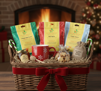Gift basket with Lynn Leaf Tea packages, a red mug, and holiday items in front of a fireplace.